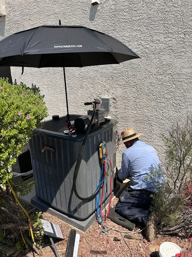 HVAC technician performing outdoor AC maintenance in Butte-Silver Bow
